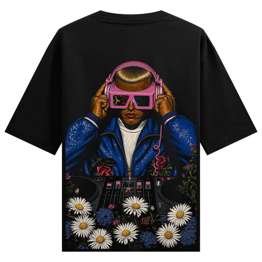 A person wearing pink headphones and a blue sequined jacket stands behind a DJ deck with daisies and roses blooming around...