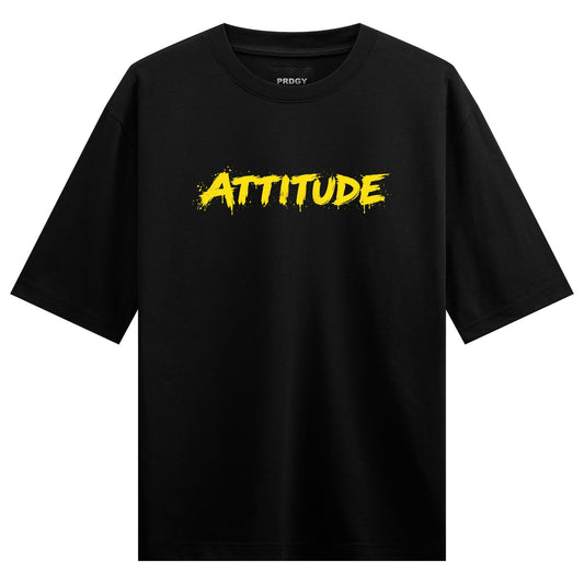 A black t-shirt features the brand name PRDGY above the word ATTITUDE in bold distressed yellow brush stroke typography on...