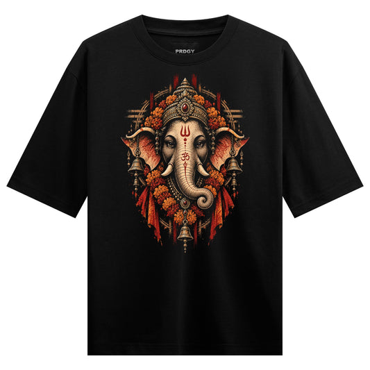A black t-shirt features a detailed print of Lord Ganesha s elephant head adorned with an ornate crown floral garlands bel...