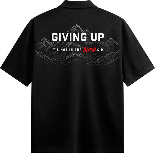 A black collared shirt with a graphic of a mountain range and the text GIVING UP and IT S NOT IN THE BLOOD SIR on PRDGY ov...