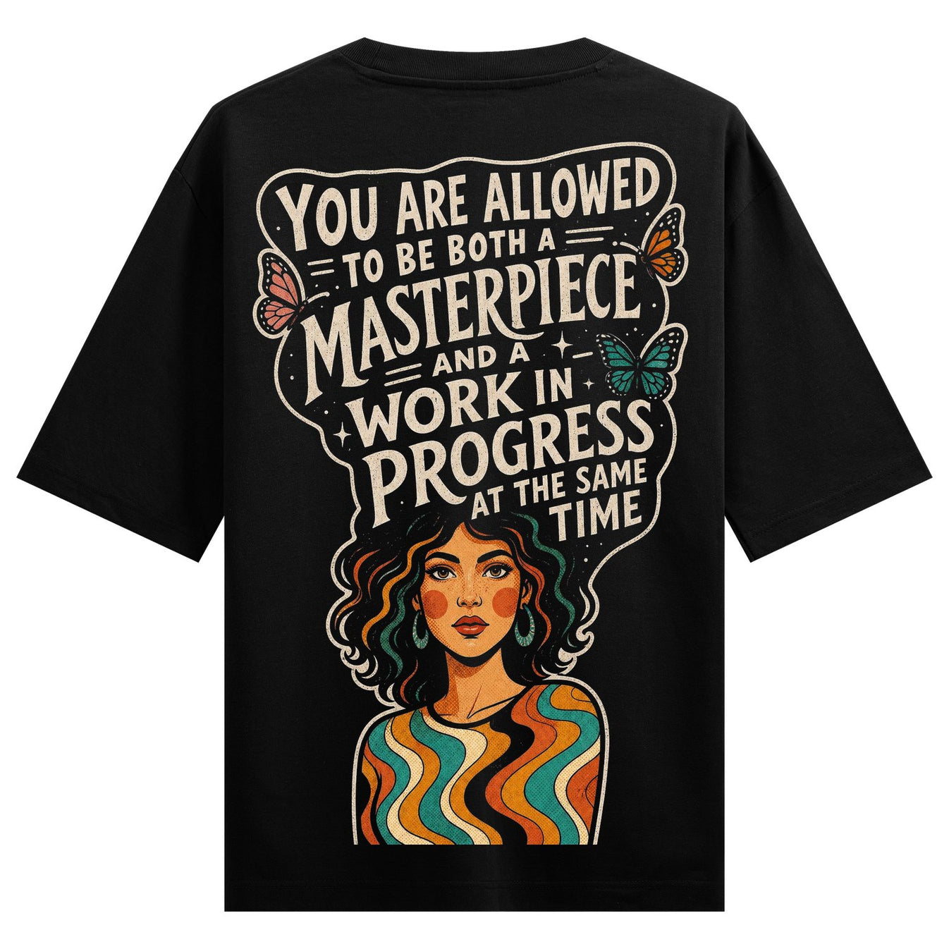 A black t-shirt back print features bold white text butterflies and a colorful portrait of a woman with wavy hair and a st...
