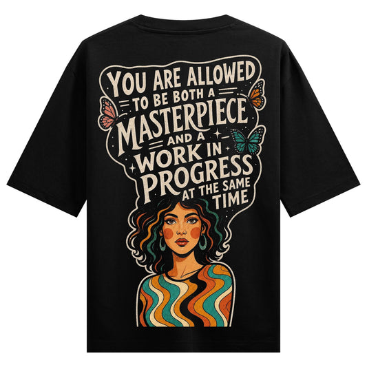 A black t-shirt back print features bold white text butterflies and a colorful portrait of a woman with wavy hair and a st...