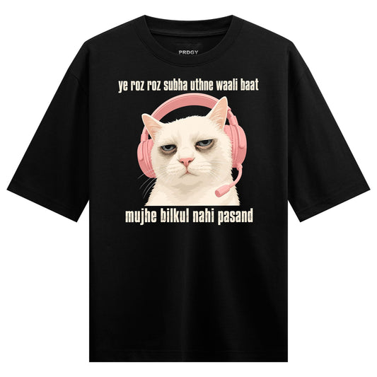 A white cat with a grumpy expression wears pink headphones with a microphone on a black t-shirt on PRDGY oversized full sl...