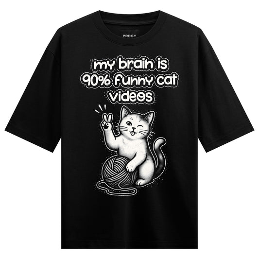 A black t-shirt features a white cartoon cat winking and holding up a peace sign sitting beside a grey ball of yarn with t...