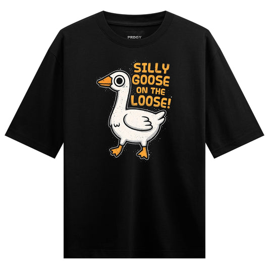 A white cartoon goose with orange beak and feet stands on a black t-shirt with yellow text above it reading SILLY GOOSE ON...