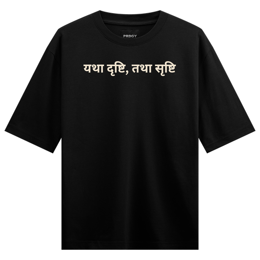 A black t-shirt with cream-colored Devanagari script text and a small brand logo at the neckline on PRDGY oversized t-shirt