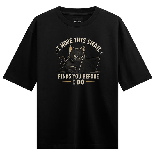 A black cat with an angry expression sits at a laptop with text above and below it on PRDGY oversized t-shirt