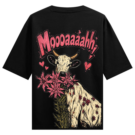 A black t-shirt with a graphic of a cow holding pink flowers in its mouth surrounded by pink hearts and bold pink text on...