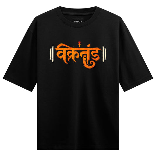 A black t-shirt features bold orange Devanagari script with a Ganesha symbol and white vertical lines on either side on PR...