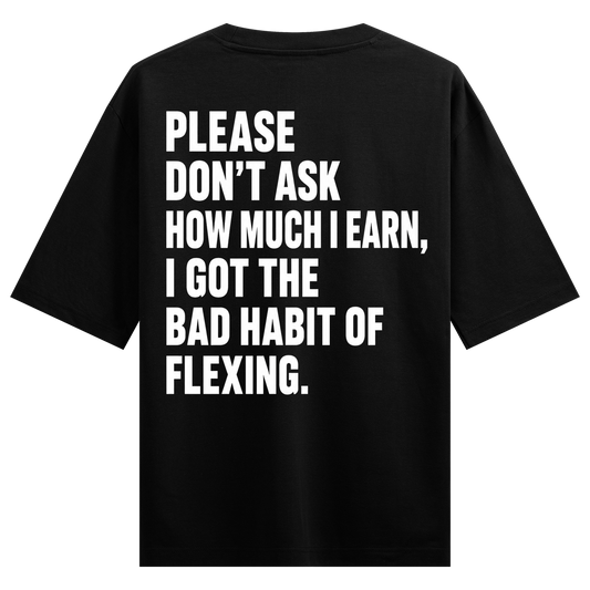 Bold white sans-serif typography is printed on the back of a black t-shirt conveying a humorous message about earning and...