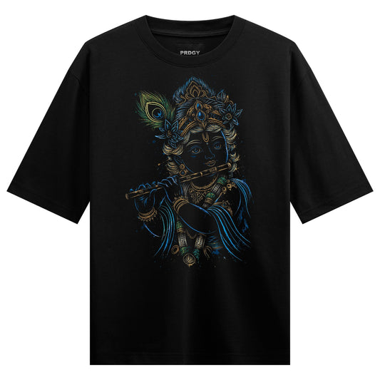 A black t-shirt features a detailed illustration of Lord Krishna playing a flute adorned with a crown and peacock feather...