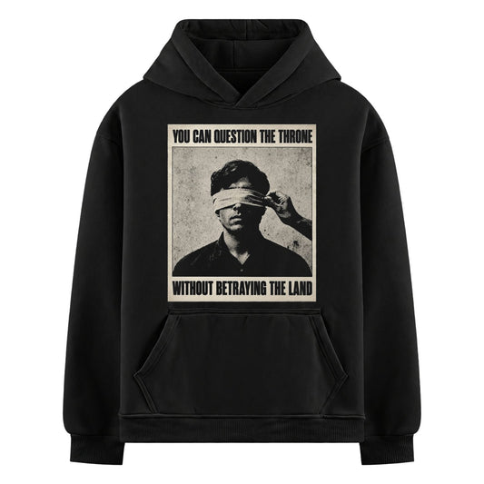 Beyond the Crown Oversized Hoodie — a central monochrome portrait of a man having a blindfold pulled over his eyes, framed