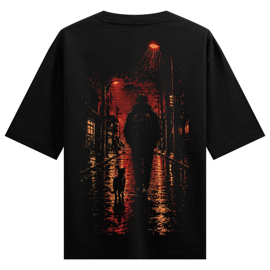 Night Walker Oversized T-Shirt — a dark graphic depicts a silhouette of a person and a dog walking on a wet street