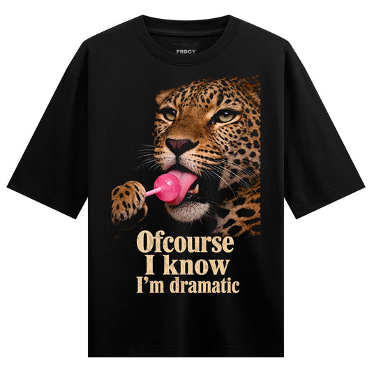 A photorealistic leopard licking a pink lollipop with the text Ofcourse I know I m dramatic below on PRDGY oversized t-shirt