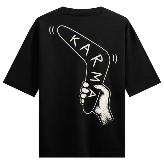 A white outline of a hand holding a boomerang with the word KARMA in white text on a black t-shirt on PRDGY oversized t-shirt