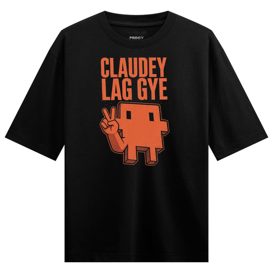 A black t-shirt features orange text and a pixelated orange character giving a peace sign with blocky features on PRDGY ov...