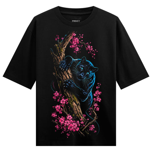A black panther with glowing blue eyes climbs a textured tree branch surrounded by pink cherry blossoms on a black t-shirt...