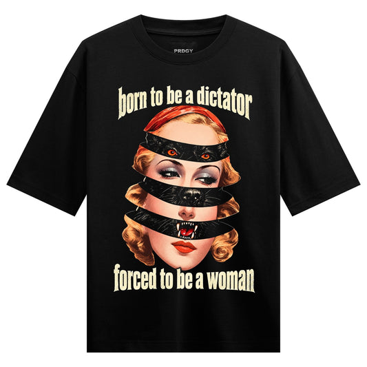 Dictator Woman Oversized T-Shirt — a woman's face sliced by black tape revealing cat eyes, fangs, red lips, and orange hair
