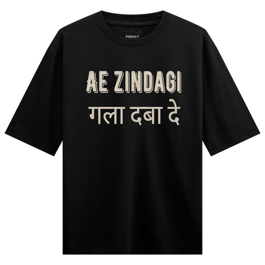 A black t-shirt with cream-colored text in English and Hindi featuring the brand name PRDGY and a bold phrase on PRDGY ove...