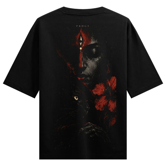 Mystic Gaze Oversized T-Shirt — a serene face with red markings, a black cat, and a red hibiscus flower
