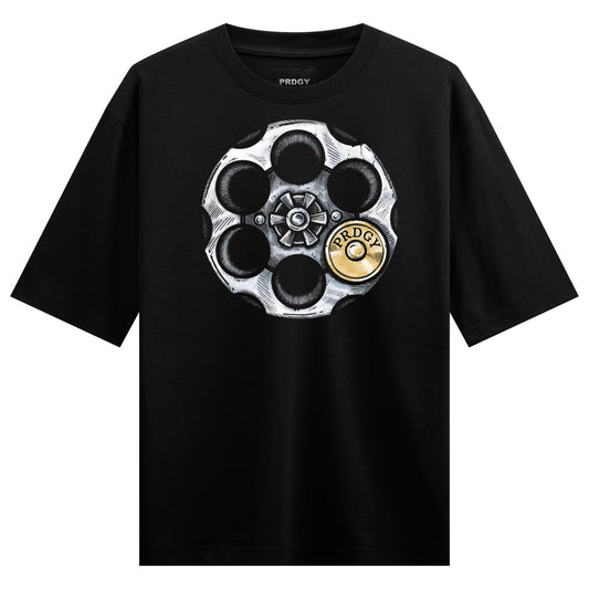 A black t-shirt features a detailed illustration of a silver revolver cylinder with six chambers one containing a gold bul...