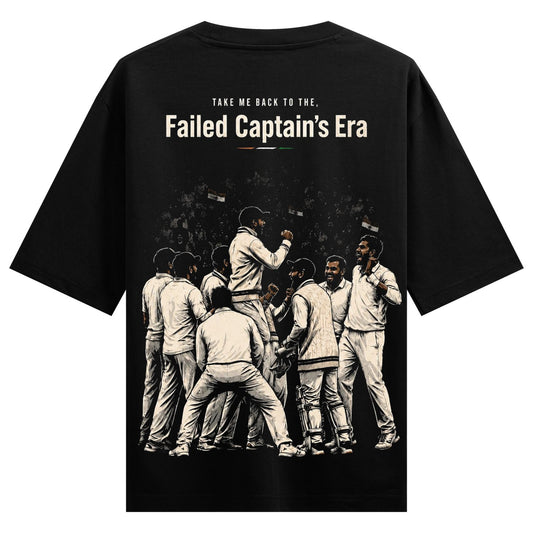 A black t-shirt back print shows a monochrome illustration of cricket players in a huddle with a cheering crowd in the bac...