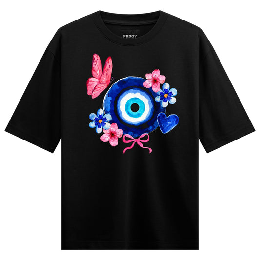 A black t-shirt features a watercolor graphic of a blue evil eye symbol with pink and blue flowers a pink butterfly and a...