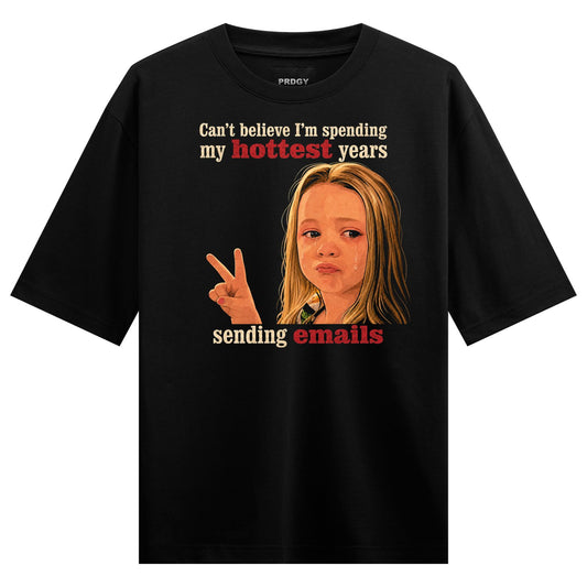 A black t-shirt features a crying girl with a peace sign and red text stating Can t believe I m spending my hottest years...