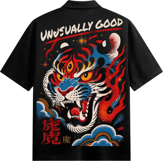 A black t-shirt back print features a stylized tiger face with red eyes and blue accents surrounded by red and orange flam...