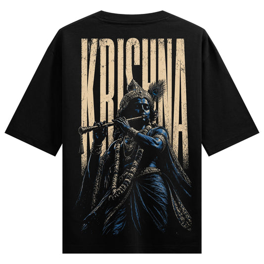 A dark graphic t-shirt design features Lord Krishna with blue skin playing a flute wearing an ornate crown with a peacock...