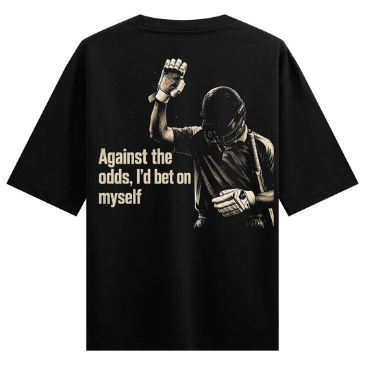 A black t-shirt back print features a gritty illustration of a cricket player in helmet and gloves raising a fist with mot...
