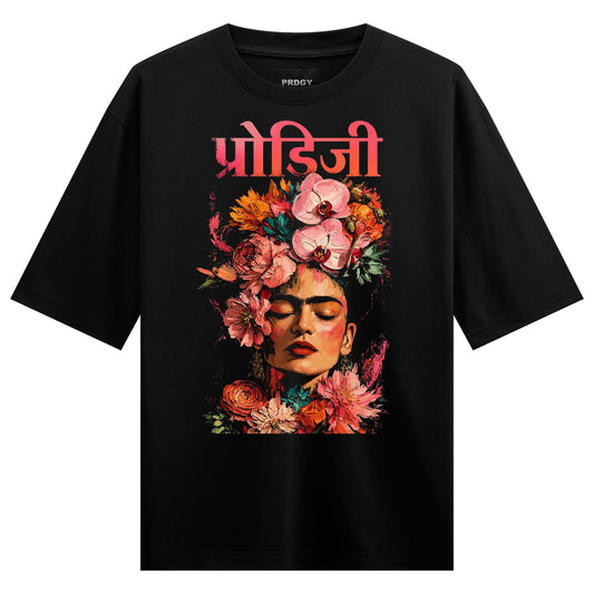 A black t-shirt features a colorful illustration of Frida Kahlo s face with a large floral headdress in vibrant pinks oran...