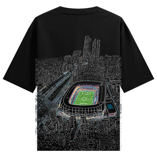 Stadium Vision Oversized T-Shirt by PRDGY — aerial cityscape with geometric line-art buildings and a vibrant soccer stadium,